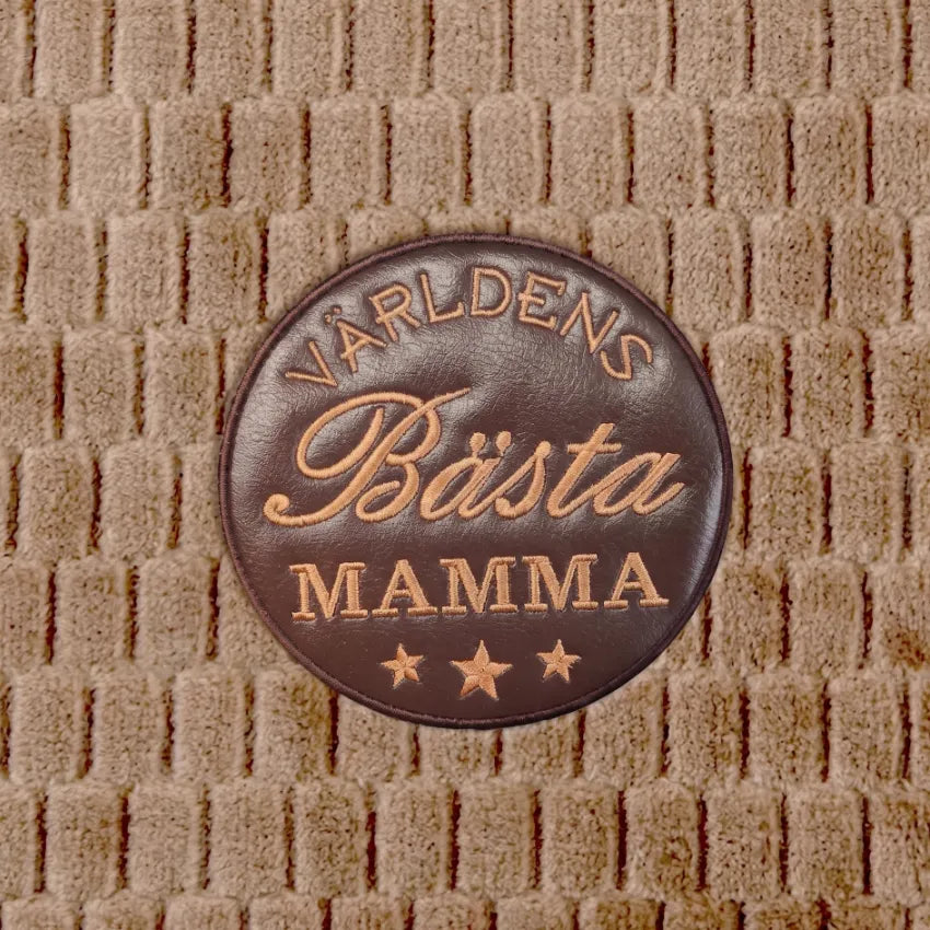 Broderad patch på fleece-pläd
